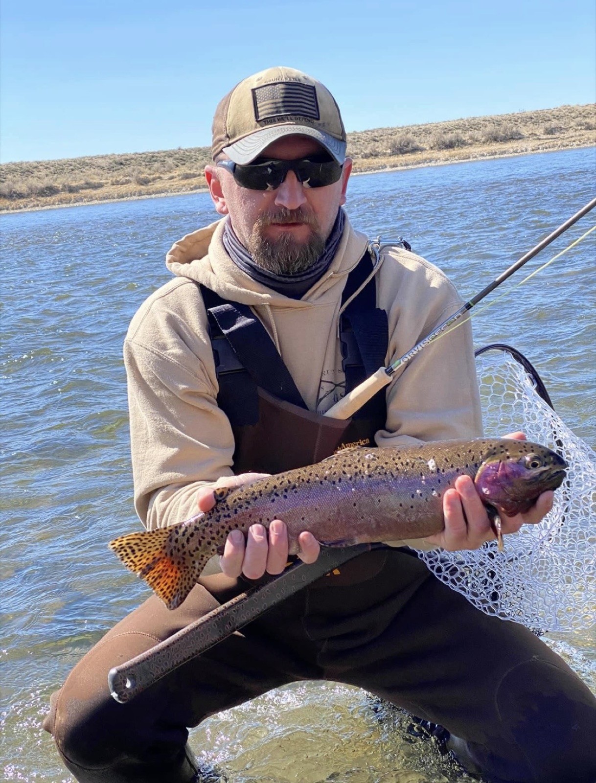 Big brown trout landed on a Wyoming river