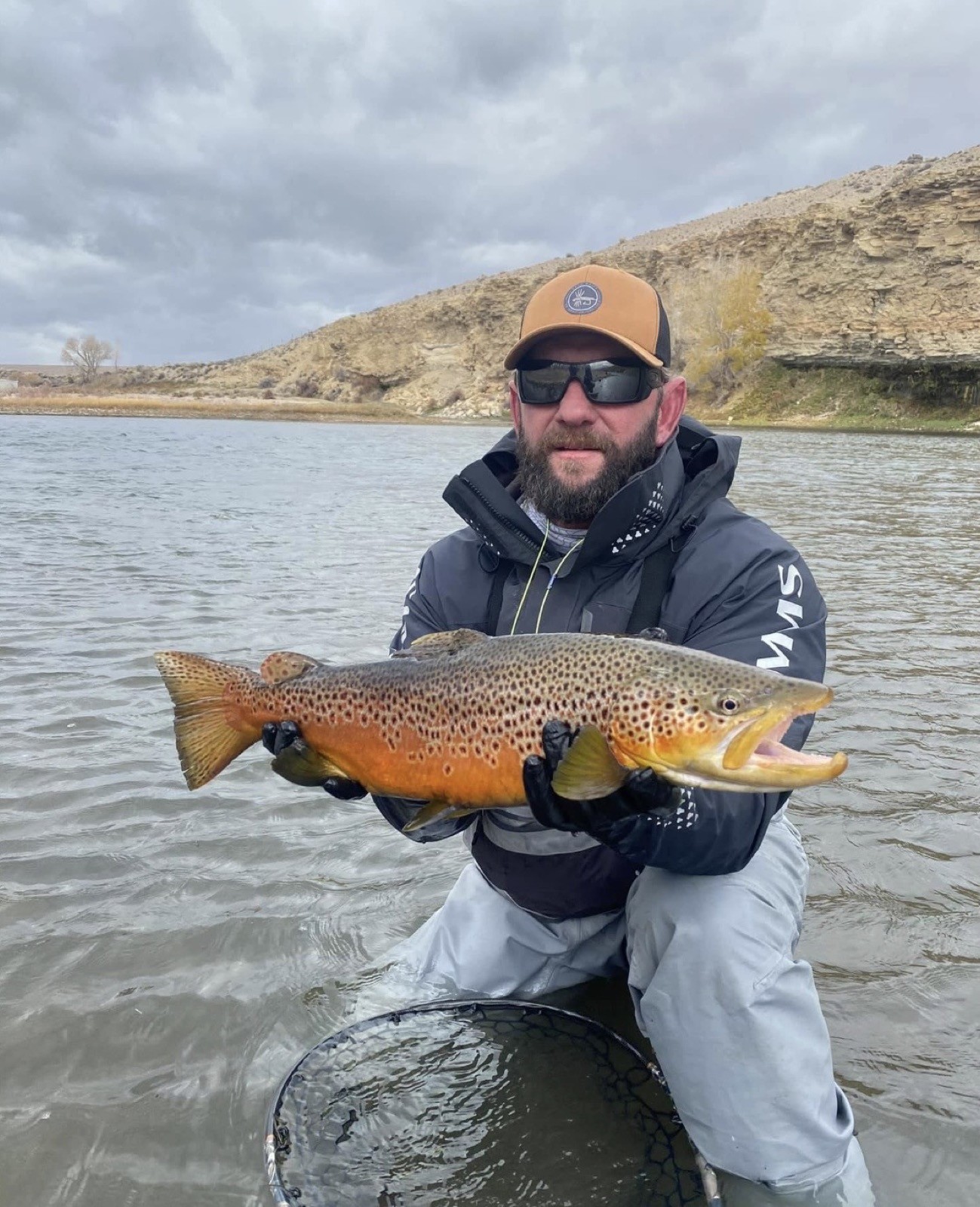 Big brown trout landed on a Wyoming river