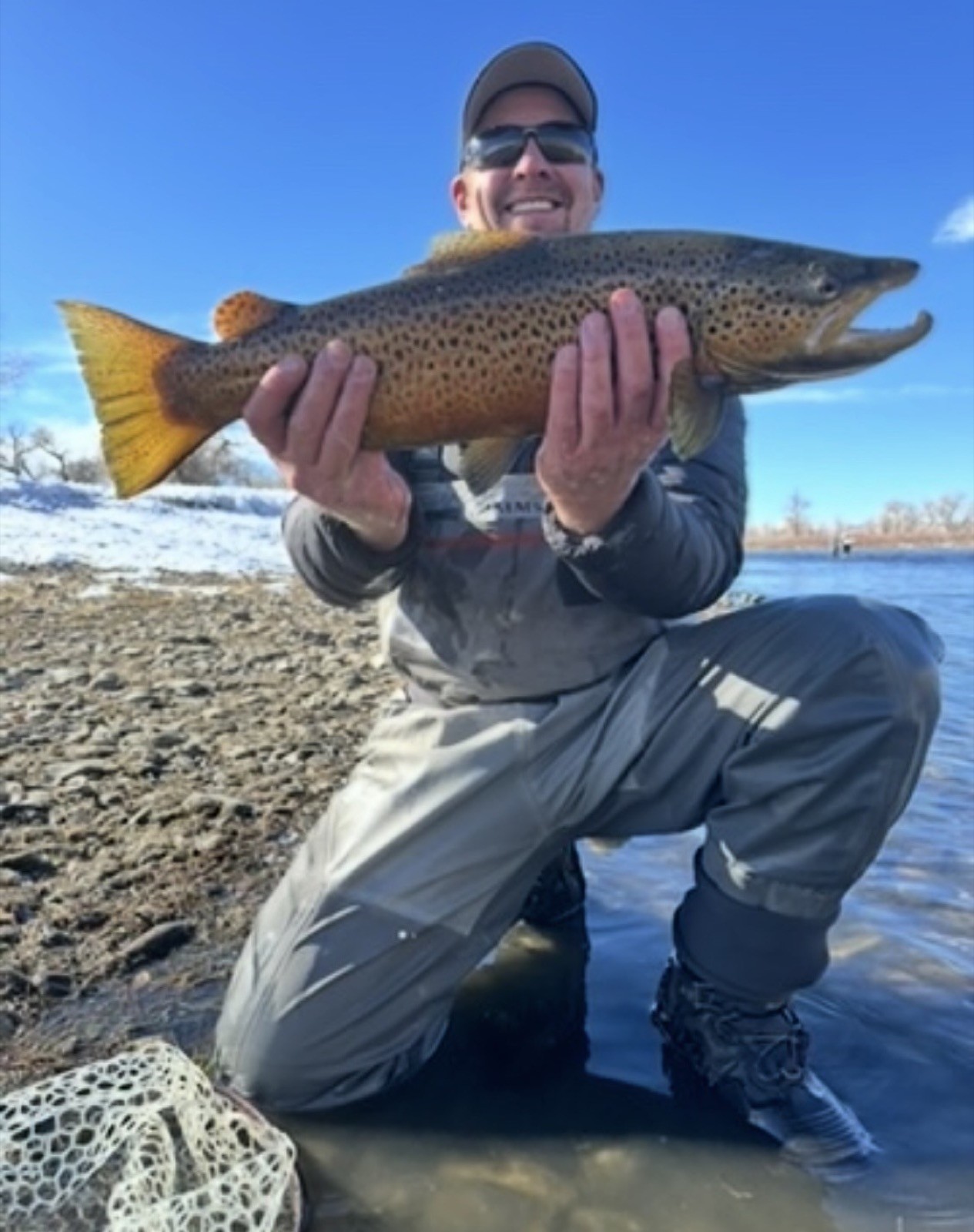 Happy angler with a beautiful trout near Rock Springs, Wyoming