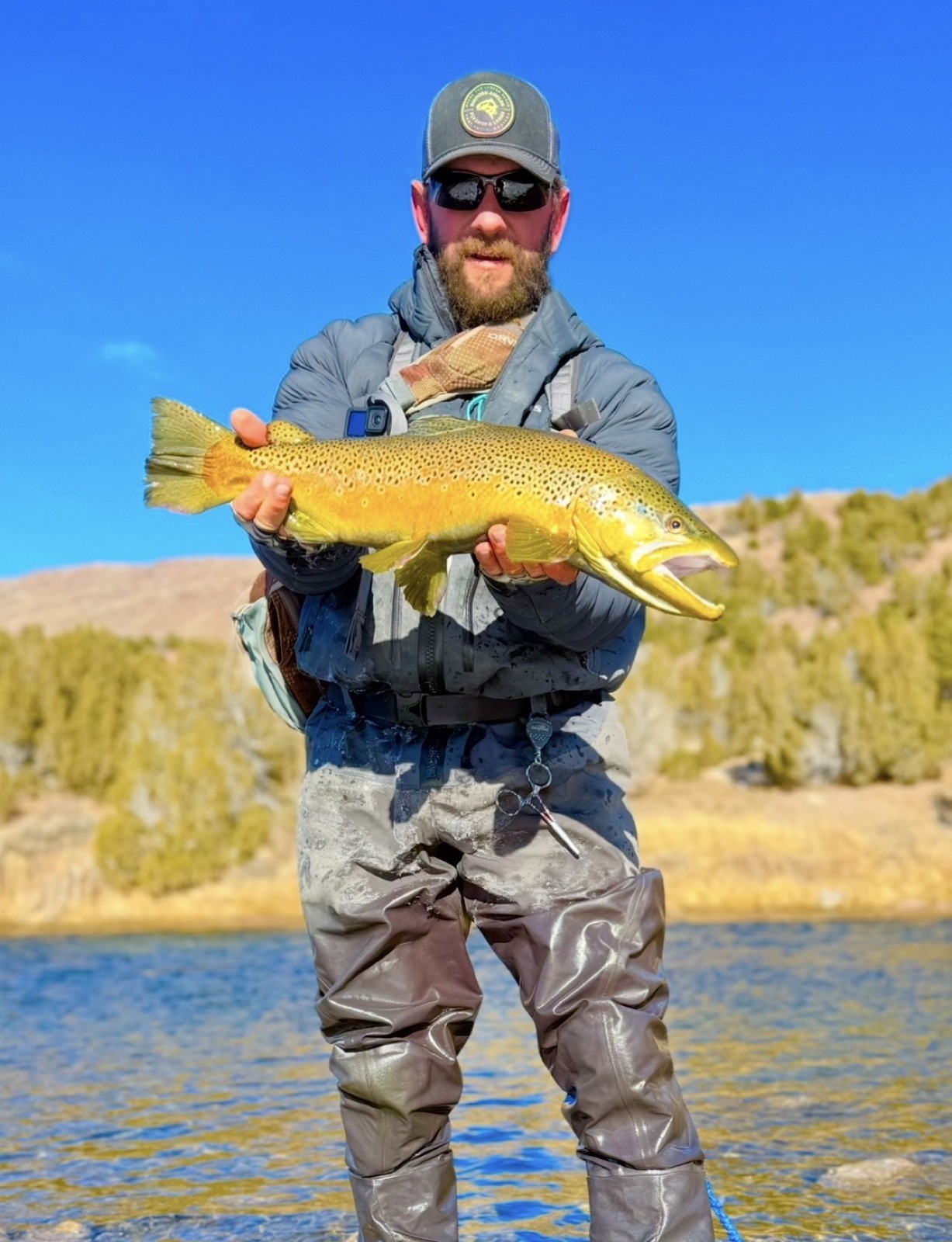 Happy angler with a beautiful trout near Rock Springs, Wyoming